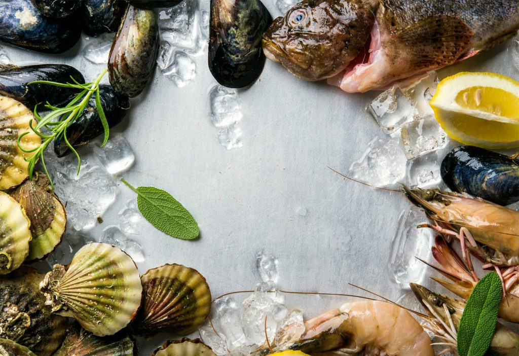 Fresh seafood with herbs and lemon on ice